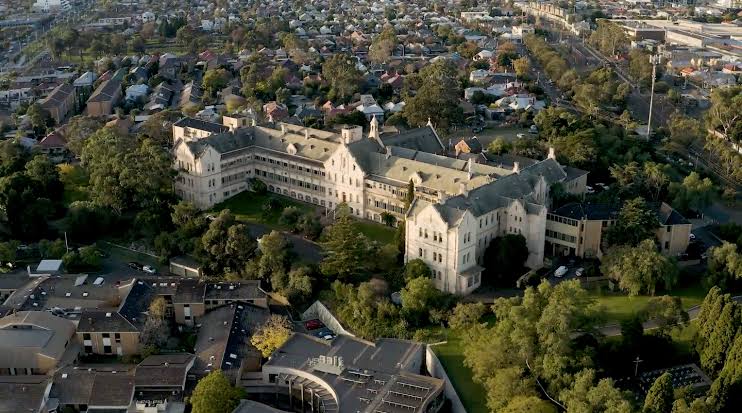 Aerial view of a historic religious complex and its surrounding neighbourhood